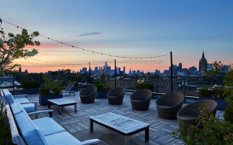 a patio with chairs and a city in the background