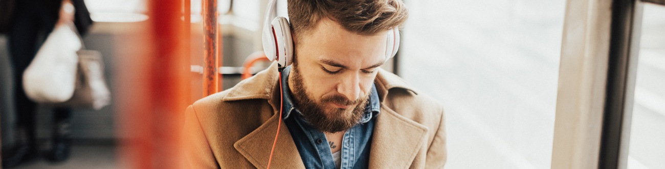 man with cell phone with headphones on