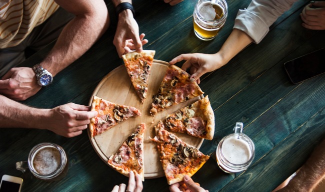 View of people sharing pizza